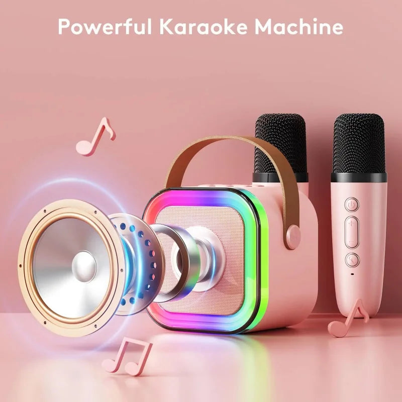 Machine karaoké portable avec haut-parleur Bluetooth LED multicolore et deux microphones sans fil, design compact avec poignée, idéale pour enfants et soirées.
